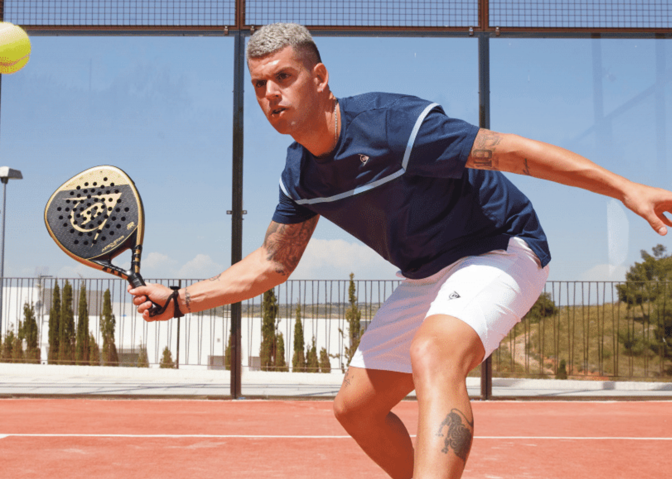 Man playing padel with a dunlop padel paddle and a ball